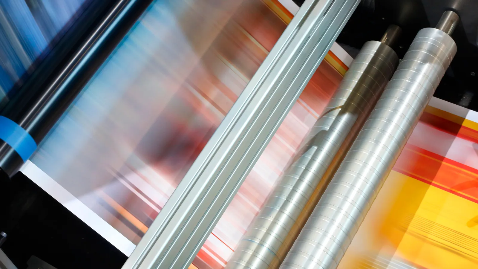 Web printing press rollers running a colour-printed web at speed