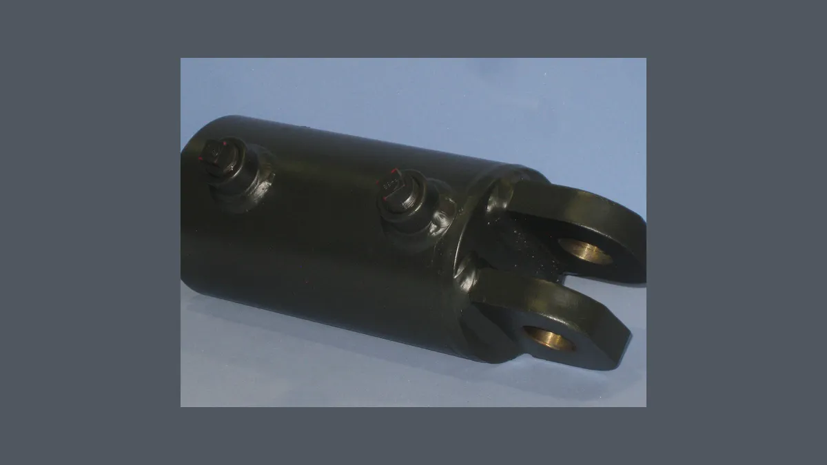 Heavy hydraulic rotary union with twin clevis eye ends lying on a shop floor
