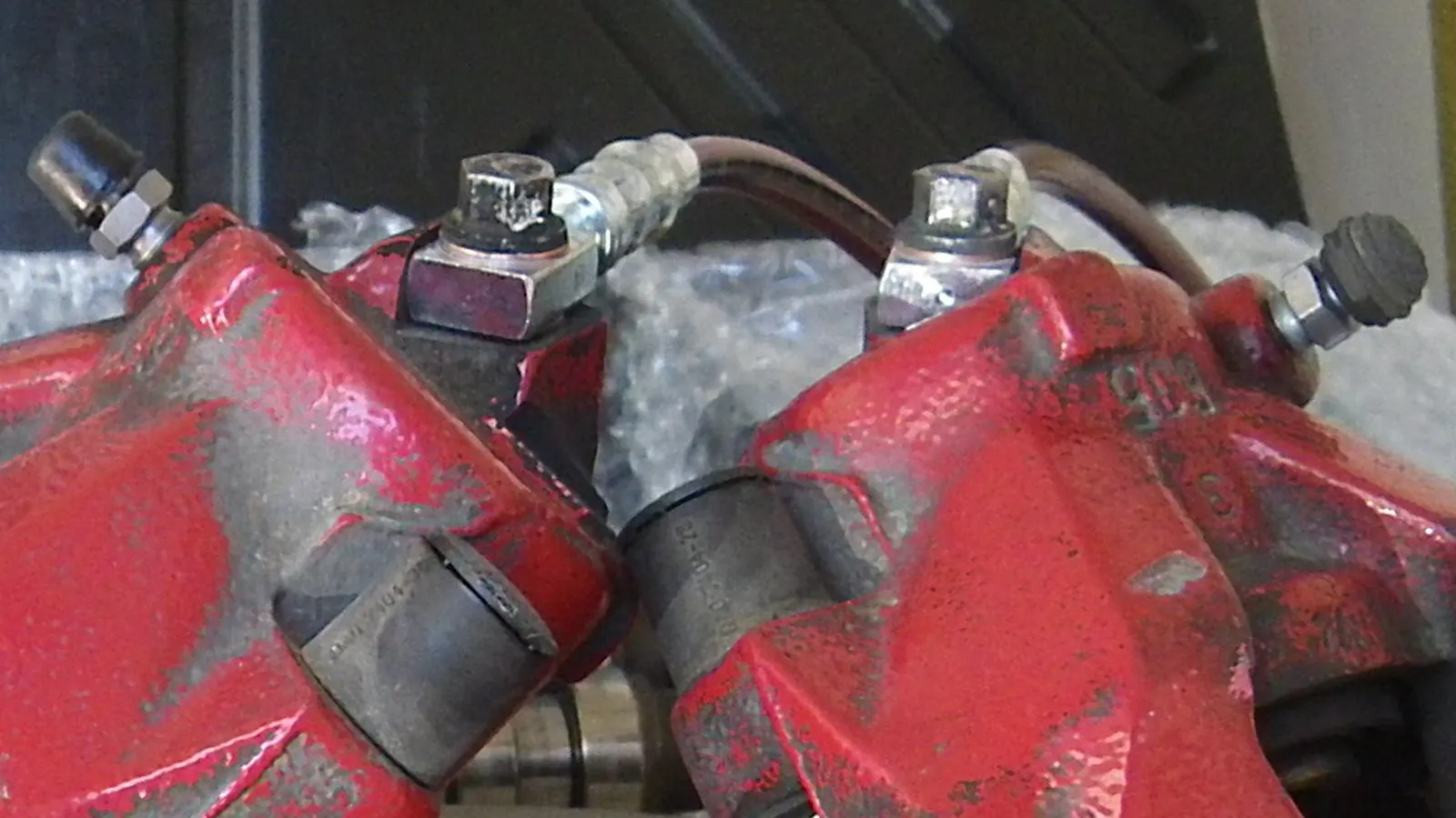 Disassembled swivel banjo fittings and brake hoses inspected during seal replacement